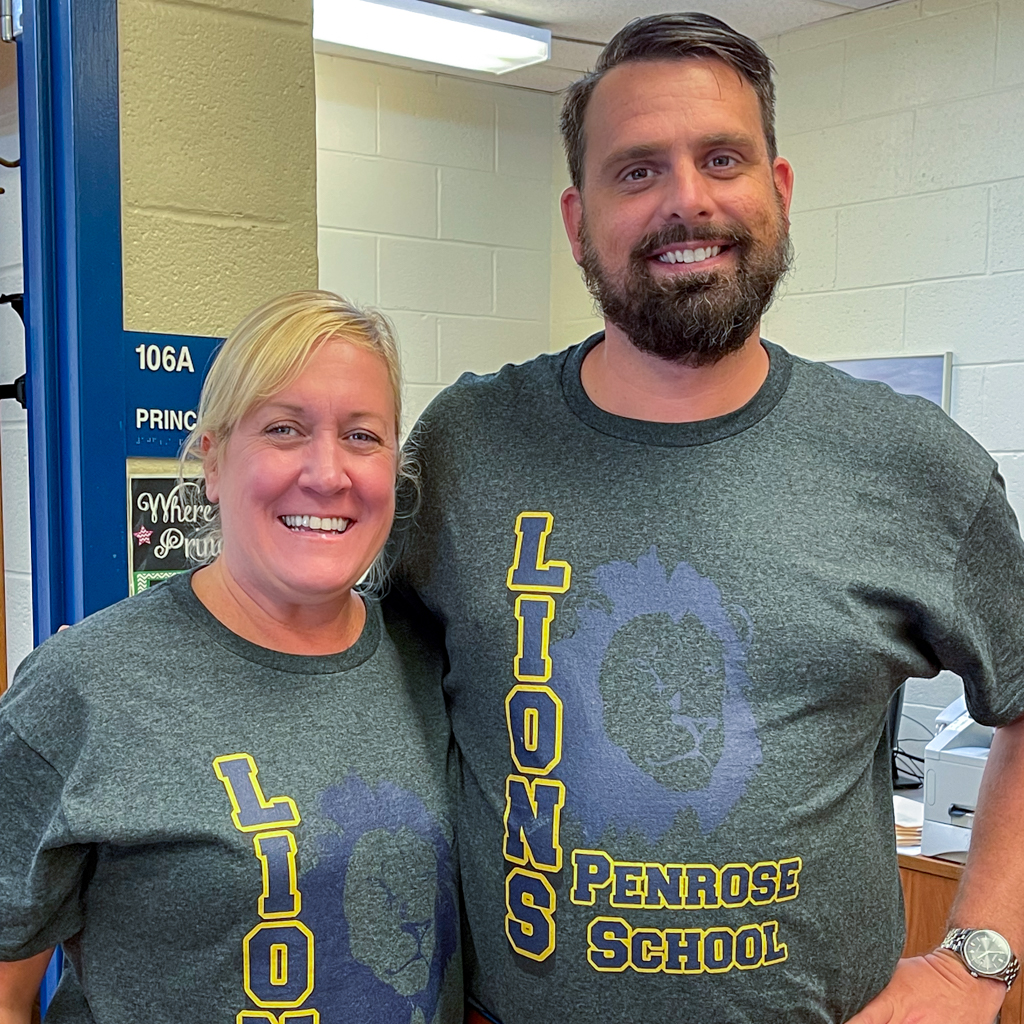 Penrose School Principals Carol Casciato and Ryan Sullivan Penrose School principals smiling in matching school shirts